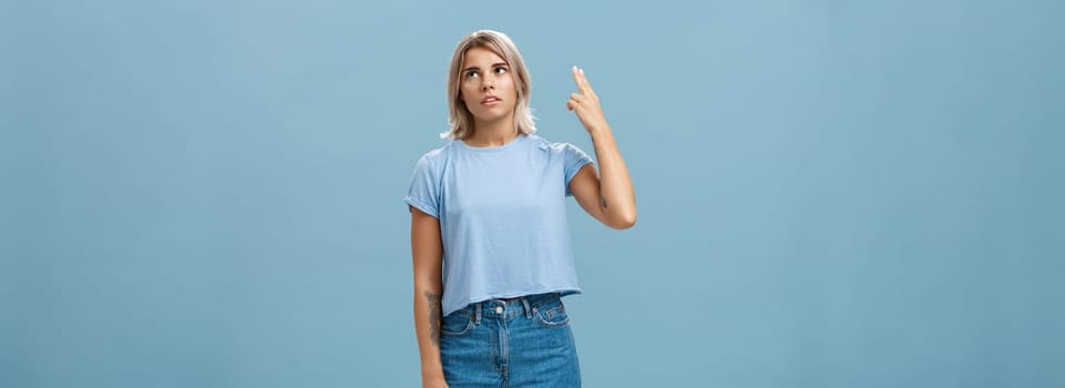 Stop teaching me how live my life. Portrait of irritated displeased attractive blonde female in denim shorts and casual t-shirt rolling eyelids from annoyance showing gun gesture as if blowing brains.