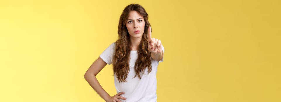 Not on my watch. Serious-looking confident empowered woman protect female rights extend index finger shaking no prohibition taboo gesture not giving permition behave cruel forbid displeased face.