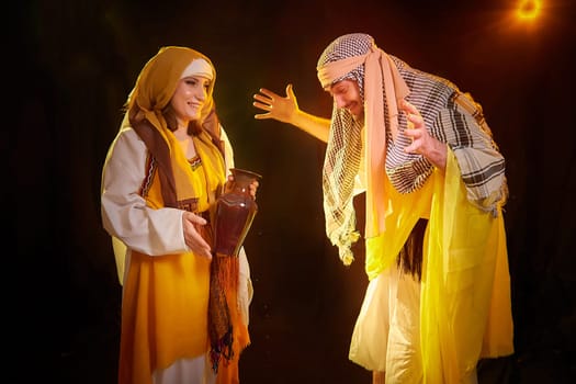 A couple in love or a married couple in stylized Eastern clothing from Israel, Palestine, Iran, Pakistan together. Tender photo session in the style of the Middle East and the Bible