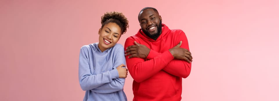 Two african american man woman couple feel comfortable warm together embracing each other cuddling happily tilting head look cute express love strong healthy relationship, smiling delighted.