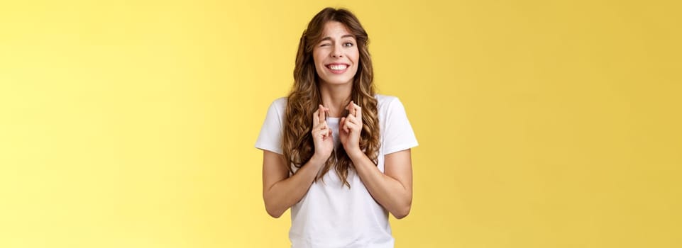 Excited happy cheerful optimistic girl peeking nervously awaiting results look one eye camera hopeful smiling broadly cross fingers good luck intense praying dream come true fulfillment wish. Lifestyle.