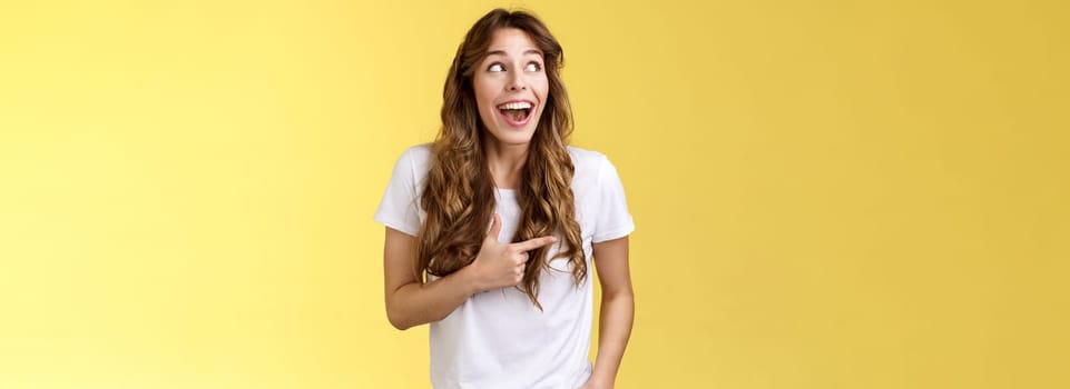 Funny amused cute girlfriend enjoy awesome party having wonderful time spend amazing day city fair open mouth surprised fascinated observe admiration lgbtq pride parade happy yellow background. Lifestyle.