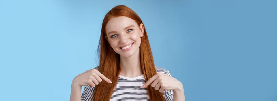 Visit place you love it. Friendly-looking kind gentle attractive redhead woman showing advertisement copy space pointing index fingers down tilting head smiling helpful recommend promo.