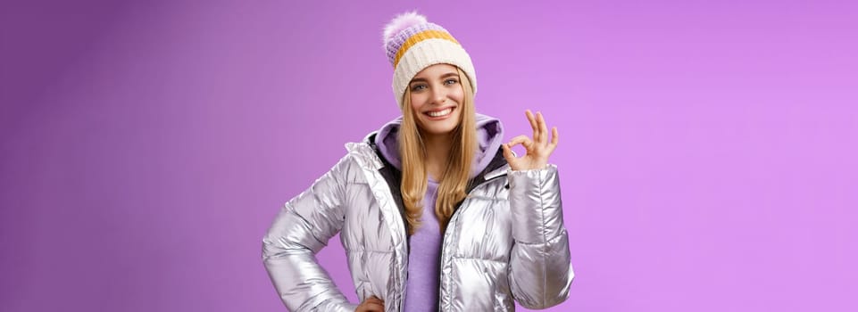 Got it count done. Portrait confident assertive charming smiling blond girl give okay assure everything perfect grinning delighted recommend awesome hotel standing self-assured purple background.