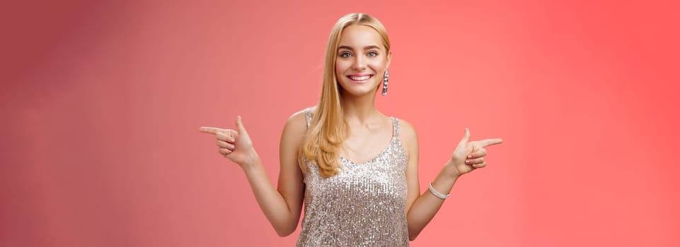 Lifestyle. Waist-up shot energized cheerful blond european girl in silver glittering dress pointing sideways left right smiling amused showing lots variants variety opportunities make choice which better.