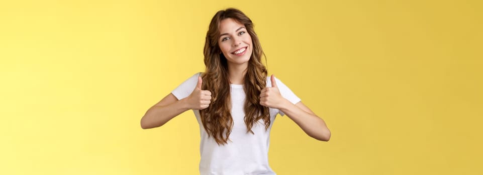 Cheerful enthusiastic young woman support lgbtq pride give thumbs-up tilt head approval like gesture accept perfect choice nodding positive reply recommend excellent service yellow background. Lifestyle.