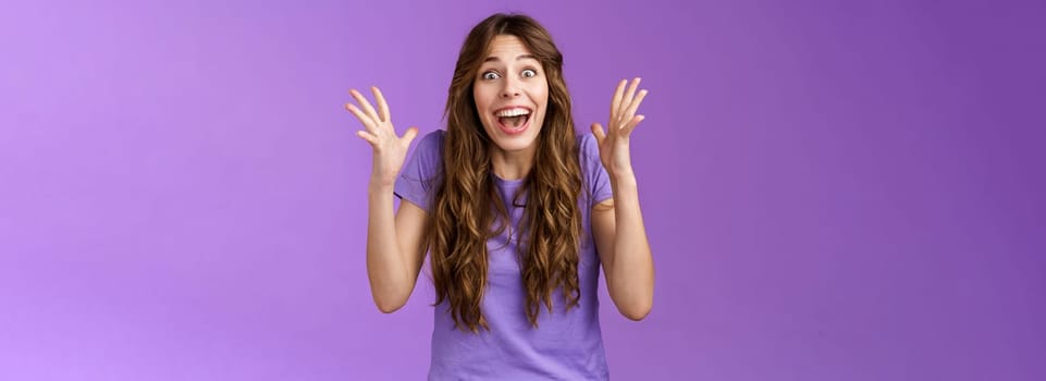 Cheerful surprised happy girl receive unbelievable super prize winning triumphing smiling joyfully shake hands excitement joy celebrating perfect news grinning happily victory purple background.