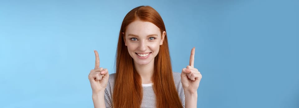 Lifestyle. Determined good-looking redhead female student enter college final decision pointing up index fingers raised confidently smiling white teeth look camera assertive giving recommendation what choose.