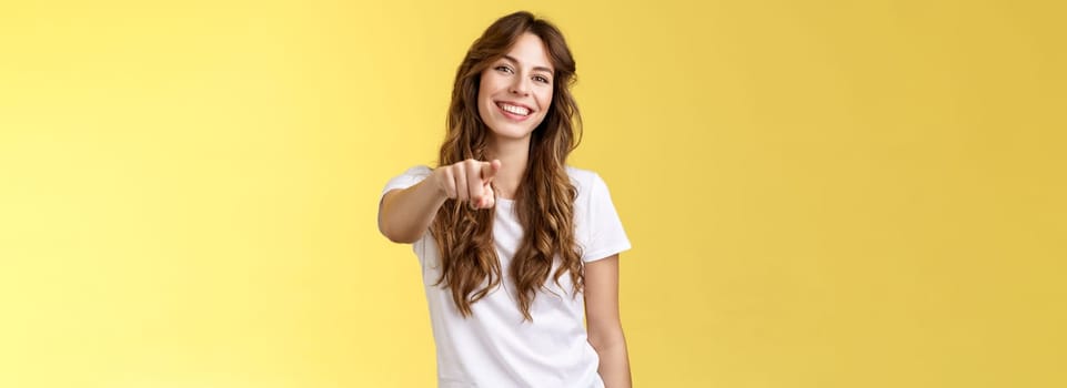Only you. Friendly cheerful good-looking curly-haired girl picking join team found excellent candidate pointing camera extend index finger indicating forward smiling delighted made perfect choice.