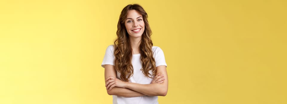 Confident carefree lively smiling female freelancer professional cross arms chest self-assured pose stand comfortable white t-shirt grinning toothy delighted stand yellow background friendly.