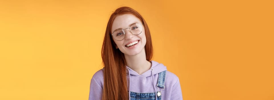 Wellbeing, lifestyle, people concept. Attractive friendly-looking smiling redhead young girl straight long natural ginger hair wearing glasses laughing happily enjoy nice relaxing cafe atmosphere.
