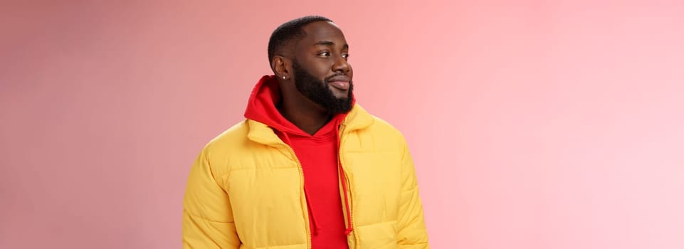 Dreamy happy optimistic black bearded man looking left daydreaming recalling nice moments, enjoying warm peaceful weather walking park feel calm relieved, standing pink background smiling cute.