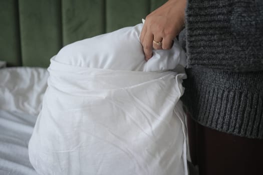 Woman Puts Pillow Into Pillowcase