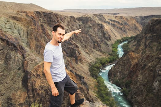 Man travels through the national parks of Central Asia, he points to the Charyn River in Kazakhstan.