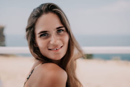 Happy woman portrait in cafe. Boho chic fashion style. Outdoor photo of young happy woman with long hair, sunny weather outdoors sitting in modern cafe