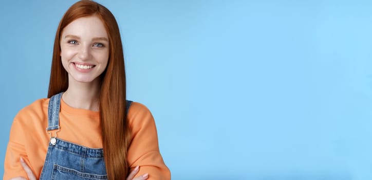 Lifestyle. Young stylish confident smiling female redhead freelancer assured job done great grinning satisfied hold hands crossed chest self-assured standing blue background good mood upbeat attitude.