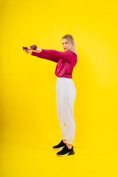 Sports woman in fashion sportswear exercising with elastic band in a studio