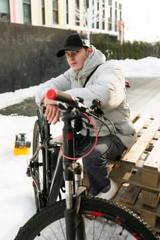 Bike rental concept. The man took a break while cycling and sat down.