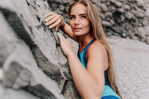 Woman travel sea. Young Happy woman in a long red dress posing on a beach near the sea on background of volcanic rocks, like in Iceland, sharing travel adventure journey