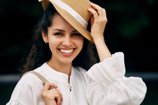 Portrait of a smiling curly-haired brunette girl in a hat. High quality photo