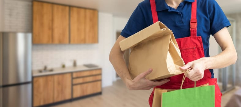 Diverse of paper containers for takeaway food. Delivery man is carrying pizza.