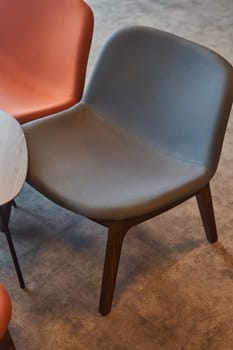 A set of wooden chairs and tables are arranged neatly in a room with hardwood flooring. The furniture adds a cozy touch to the house