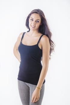 A woman is captured striking a pose for a photo while wearing a black tank top. The image showcases her confident demeanor and stylish outfit choice.