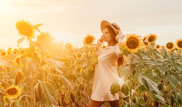 Woman in the sunflowers field. Summer time. Young beautiful woman standing in sunflower field.