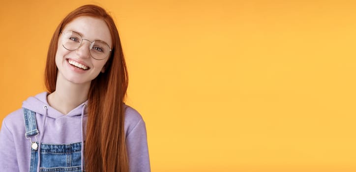 Wellbeing, lifestyle, people concept. Attractive friendly-looking smiling redhead young girl straight long natural ginger hair wearing glasses laughing happily enjoy nice relaxing cafe atmosphere.