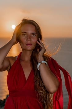 Woman sunset sea red dress, portrait happy beautiful sensual woman in a red long dress posing above the sea on sunset