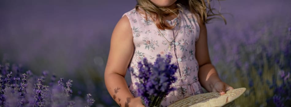 girl lavender field banner in a pink dress holds a bouquet of lavender on a lilac field. Aromatherapy concept, lavender oil, photo shoot in lavender.