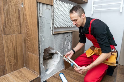 Construction worker with spirit level working on home renovations. High quality photo