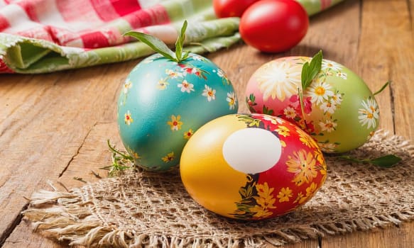 Hand-painted Easter eggs on a floral linen background, reflecting the warmth and tradition of the Easter holiday.