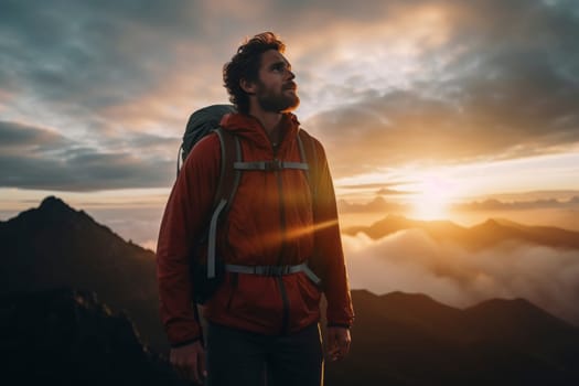 Man in orange jacket enjoying sunrise in mountains. Outdoor adventure and exploration concept for poster, wallpaper. Portrait with scenic nature backdrop and place for text