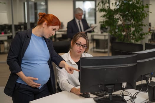 Caucasian pregnant woman giving instructions to subordinate in office