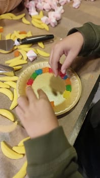 hands child boy playing with yellow candy. High quality photo