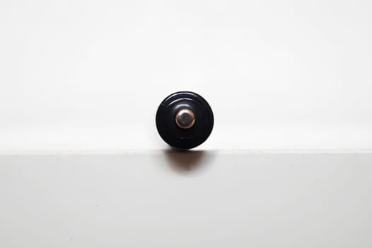 Single AAA-Size Battery Upright on a White Surface