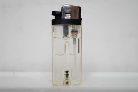Transparent Lighter Against a White Background Showcasing Its Inner Mechanism