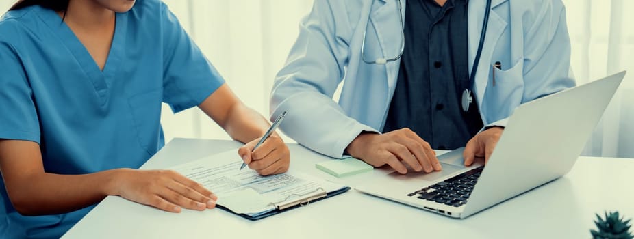 Professional various team of medical working and planning medical treatment at hospital table together. Teamwork lead to successful illness and sickness treatment. Panorama Rigid