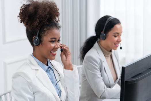 Business people wearing headset working in office to support remote customer or colleague. Call center, telemarketing, customer support agent provide service on telephone video conference call crucial