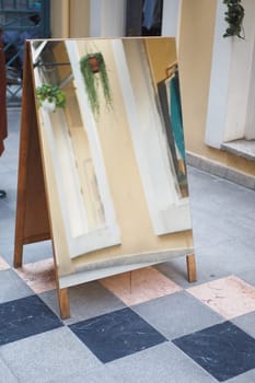 a mirror is placed on a tile flooring .