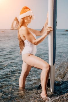 Close up shot of happy young caucasian woman looking at camera and smiling. Cute woman portrait in bikini posing on a volcanic rock high above the sea