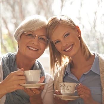 Portrait, smile and woman with senior mother drinking coffee at breakfast in the morning, bonding and happy in house. Face, elderly mom and daughter with tea cup, love and family at home together.