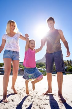 Parents, swing and holding hands with child at beach in portrait with care, love or bonding in summer on holiday. Father, mother and daughter with games, connection or playing in sunshine on vacation.