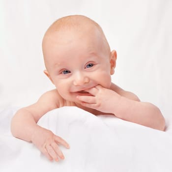 Studio, playful and baby in white background, portrait and face of innocent infant, youth and adorable. Young child, cute and healthy with skincare, soft and toddler with glow, shine and closeup.