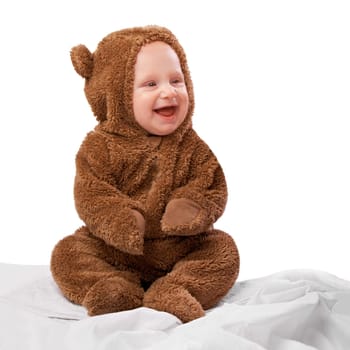 Studio, toddler and onesie with costume, bear and child with joy and fun. Baby, newborn and happiness with adorable, comfort and dressed up infant for development isolated on white background.