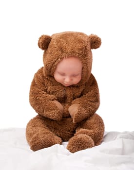 Growth, development and portrait for baby in studio with bear costume or pajamas against white backdrop. Boy, child or toddler with teddy clothes and adorable and cute for bed, cuddle and cozy.
