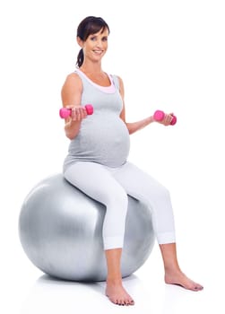 Portrait, pregnant and mother on ball for fitness, wellness and training for expectant mom on white background. Female person, pregnancy or woman with dumbbells for exercise, health or yoga in studio.