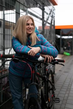 Nice young woman going for a bike ride in winter.