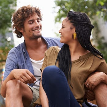 Diverse couple, outdoor and smile for bonding, park and date together in summer for boyfriend and girlfriend. Multiracial, male and female for nature, happy and love for outside of city life.
